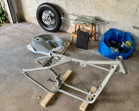 The frame stripped bare on the garage floor, every part removed