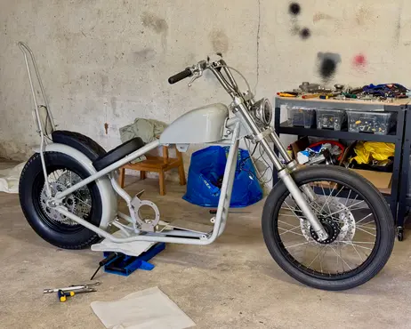 The painted frame back in the garage with its wheels and forks refitted