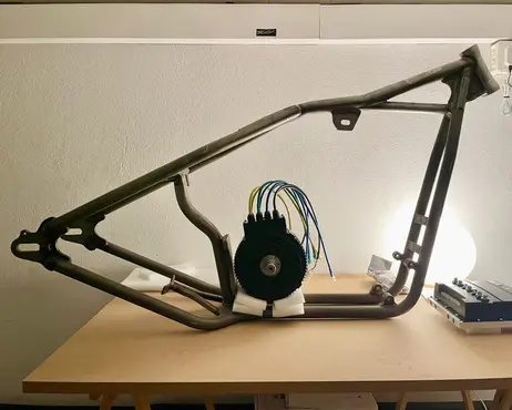 The bare frame on a table, the motor set into it loosely