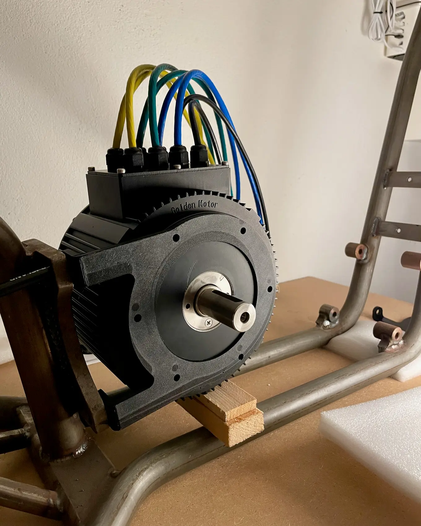 The motor and its drive sprocket held up against the frame