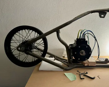 The rear wheel in the frame beside the motor
