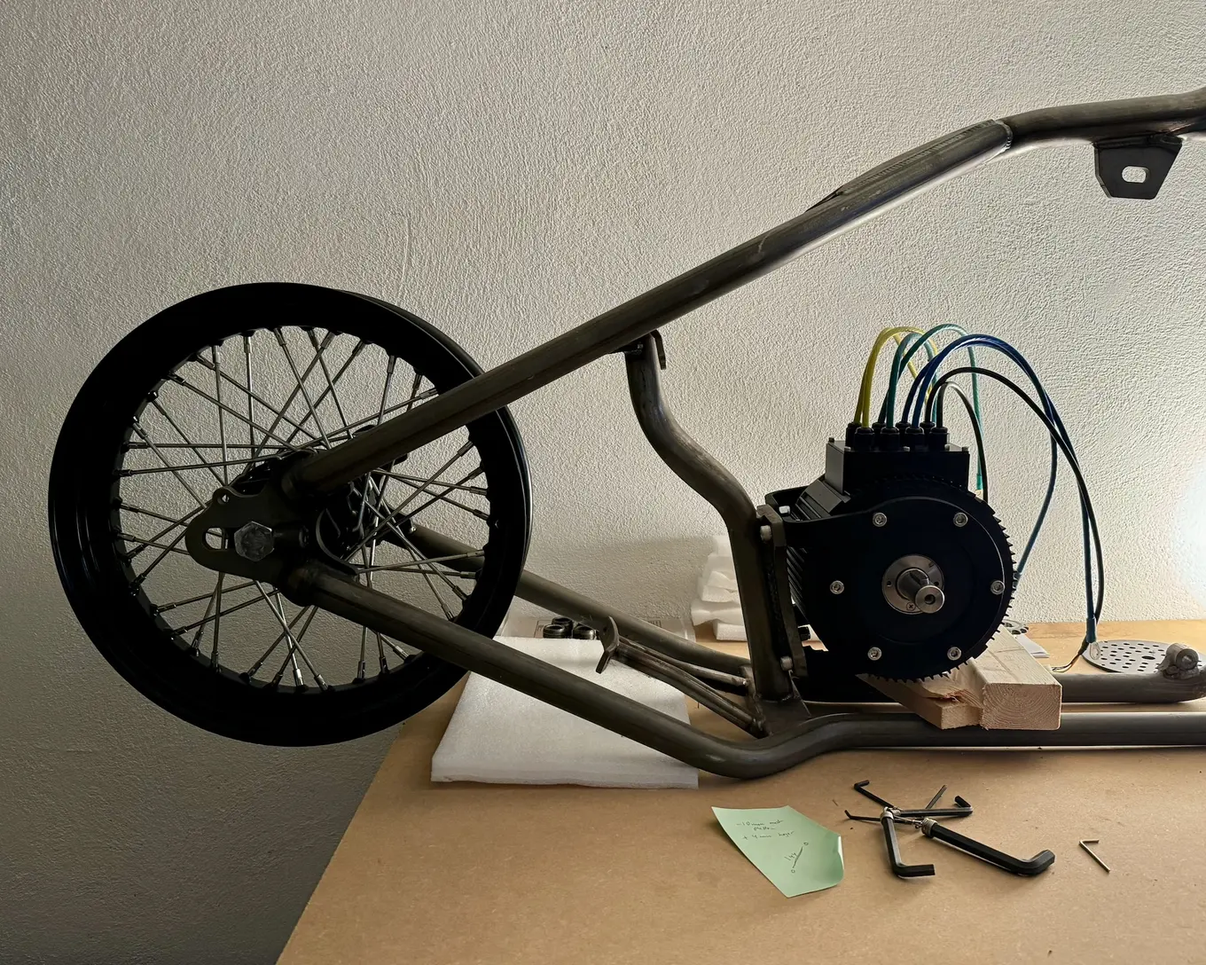 The rear wheel in the frame beside the motor