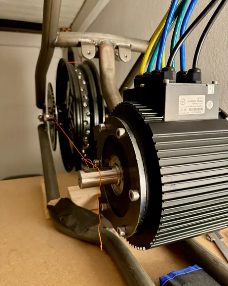 The motor's drive sprocket lined up with the rear sprocket behind it