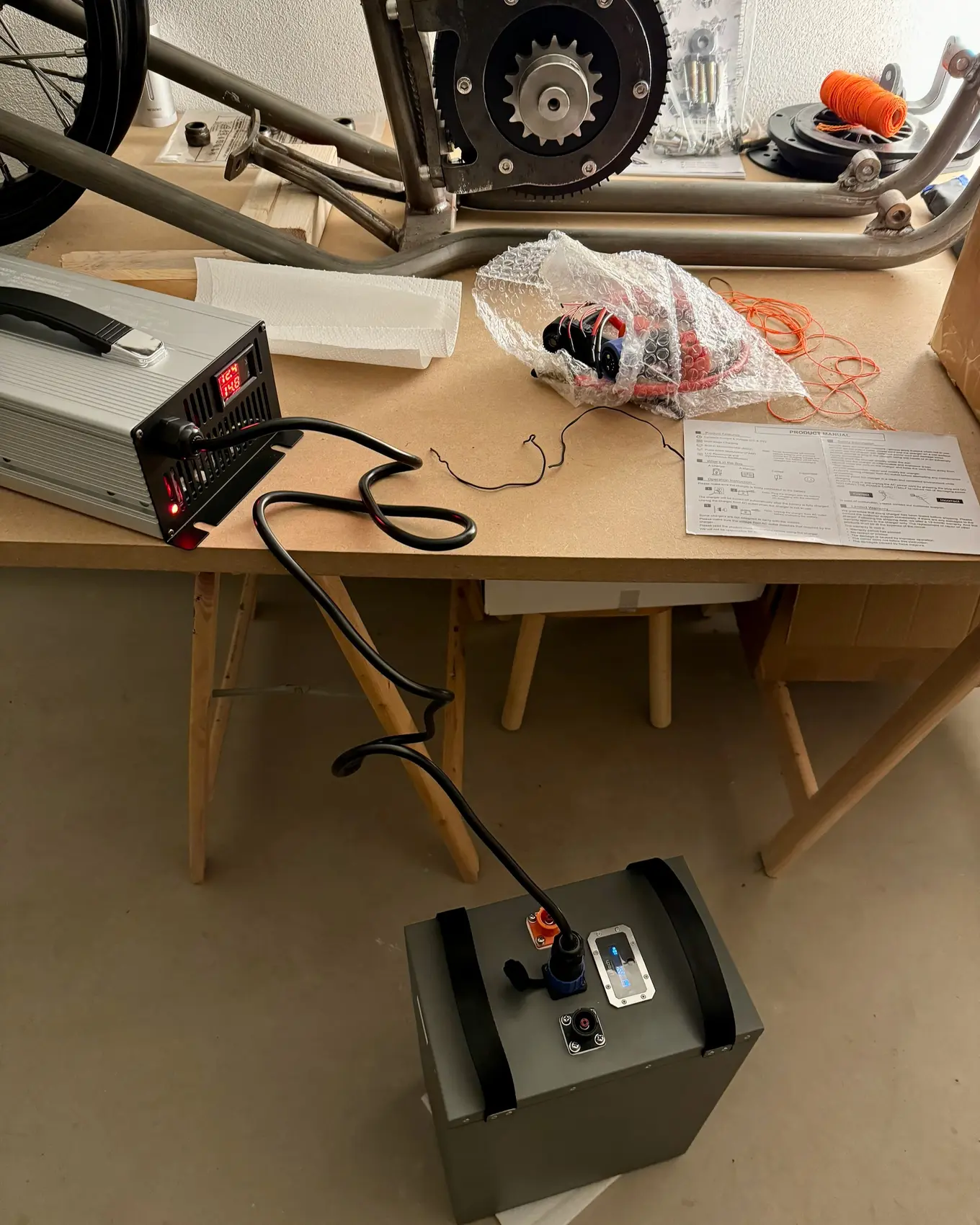 The charger on a stool beside the workbench