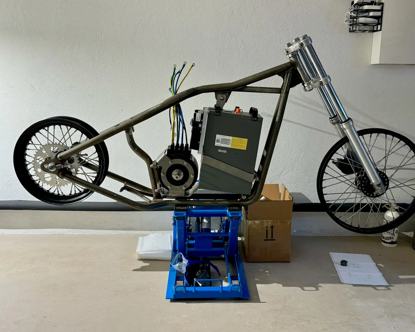The rolling chassis on the floor, forks and both wheels fitted
