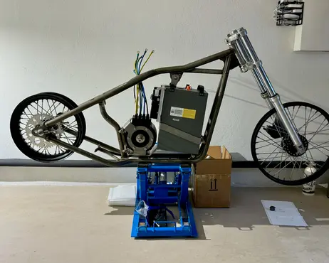 The rolling chassis on the floor, forks and both wheels fitted