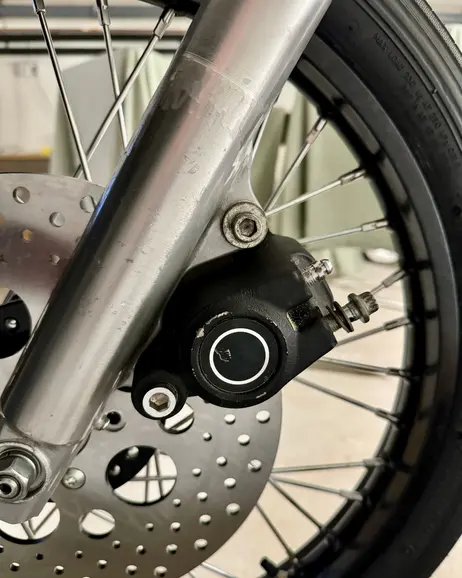 The front brake disc and caliper on the wheel