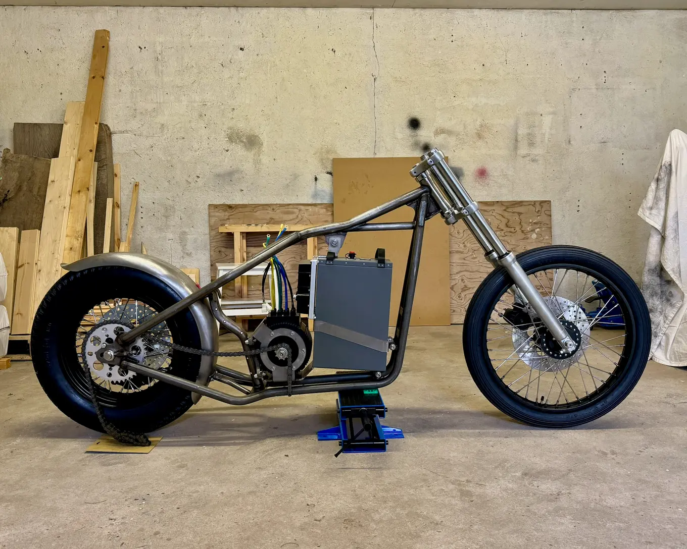 The rolling chassis standing in the garage, forks and battery fitted