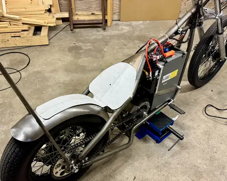 The bike with the primed fender and seat base fitted