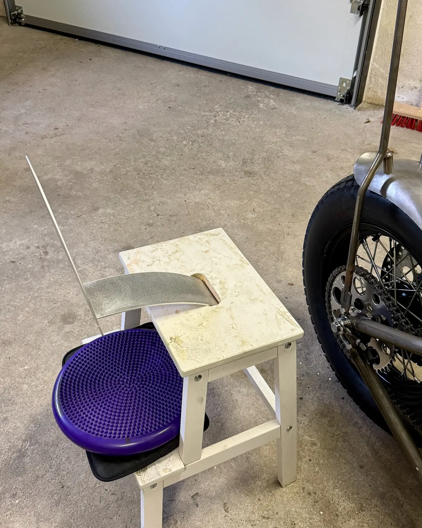 The seat pan resting on a stool beside the bike