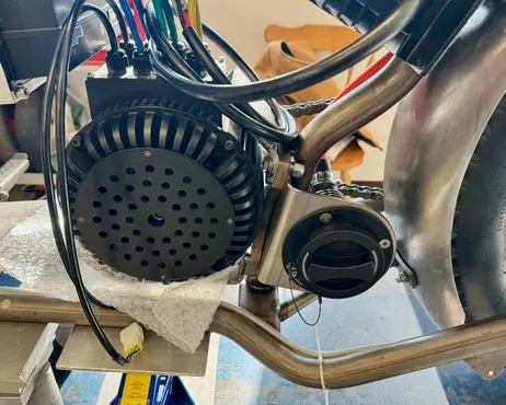 The finned cover fitted over the motor on the drive side
