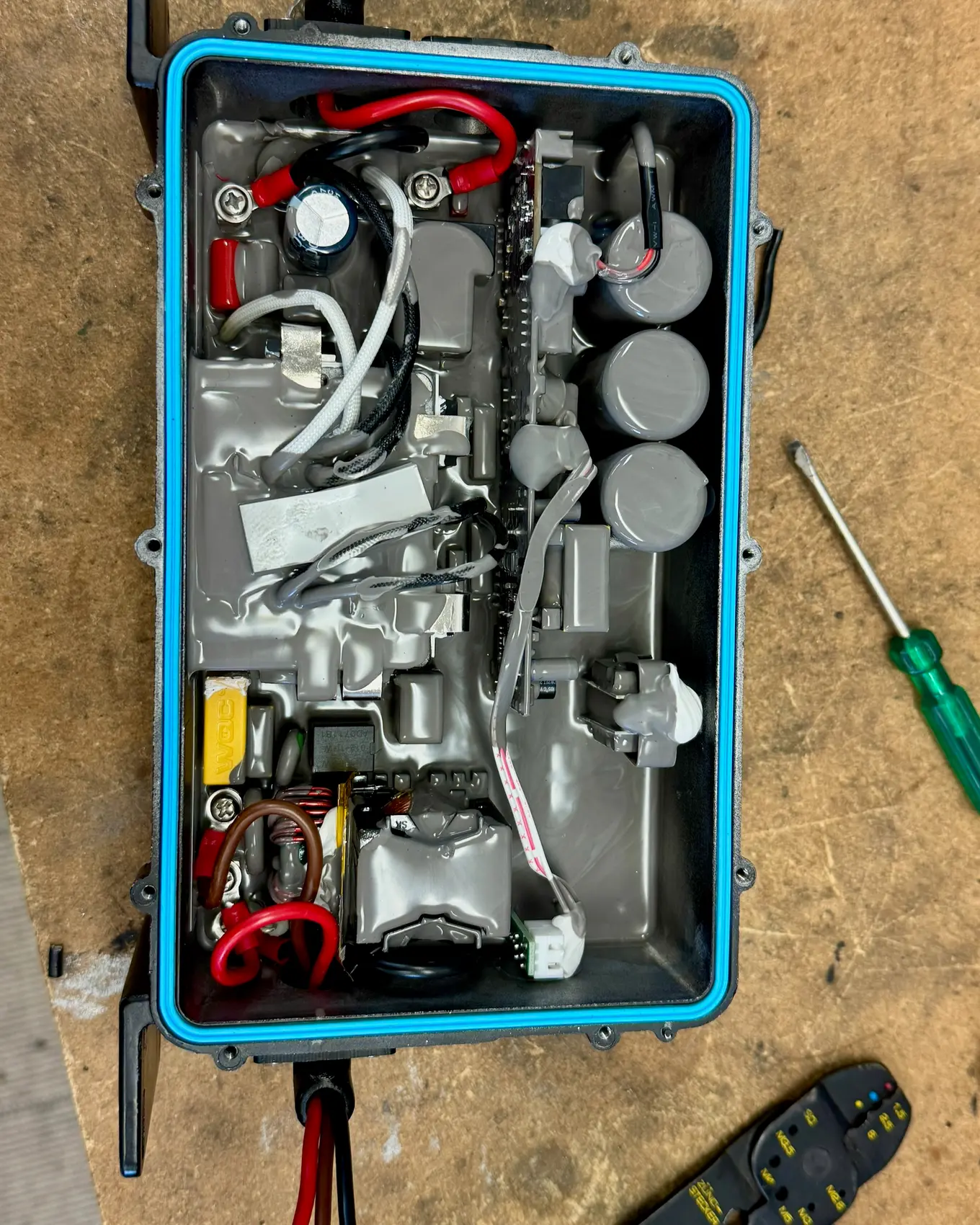 The high-voltage components laid out in a case on the bench