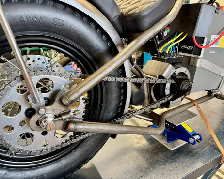 The rear wheel and drive side with the new wiring run along the frame