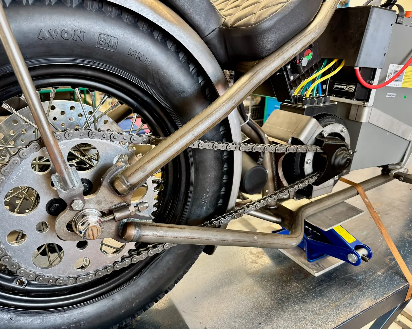 The rear wheel and drive side with the new wiring run along the frame