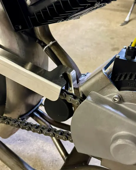 The chain guard mounted above the chain, seen from the drive side