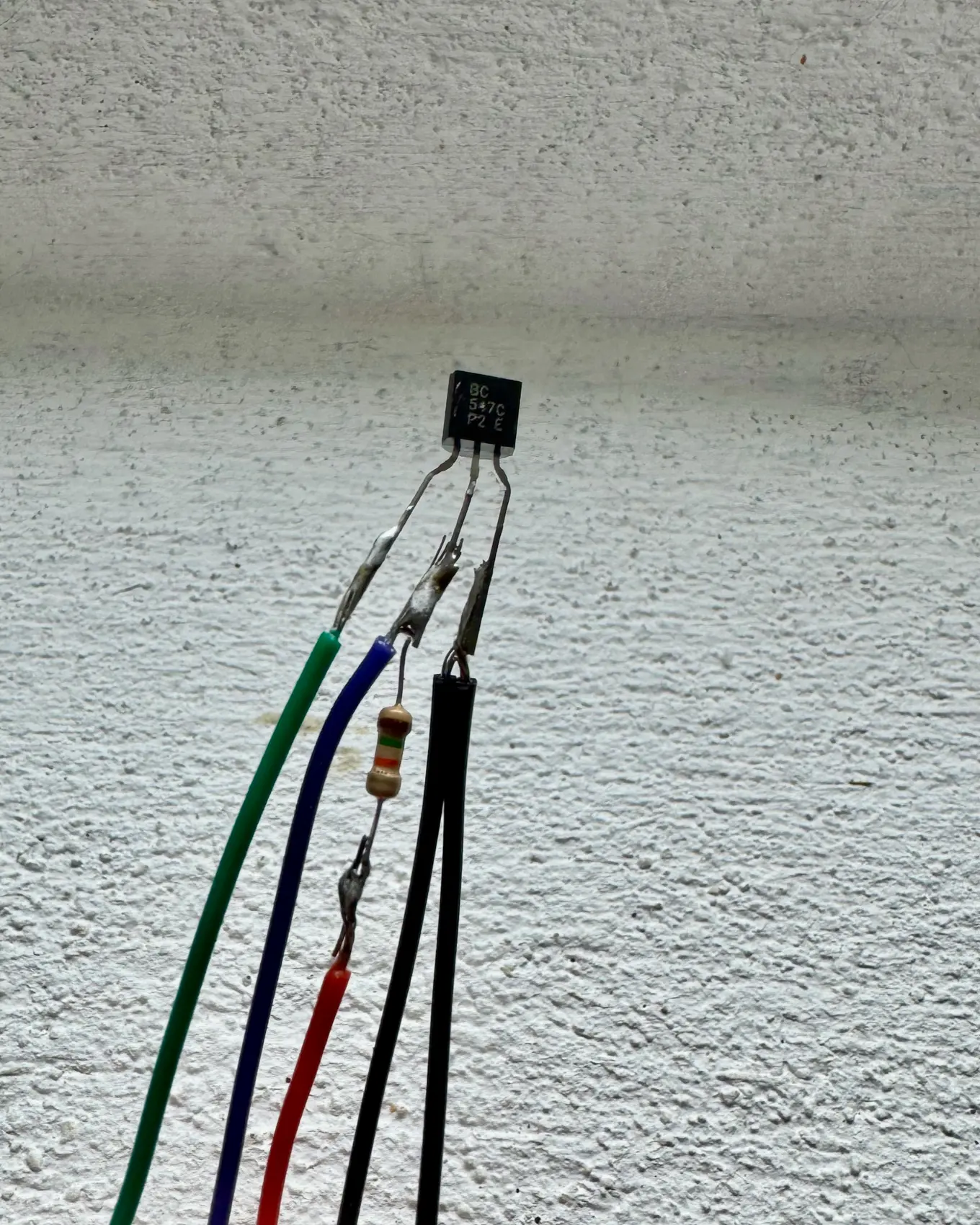 A handful of new wires held against the wall