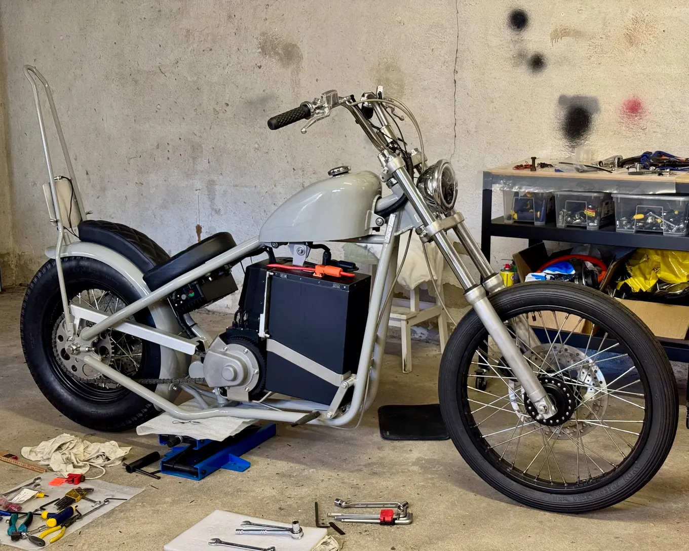 The whole bike on the garage floor, wiring done and battery in