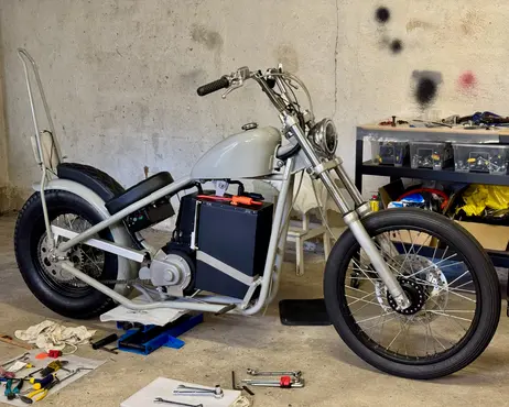 The whole bike on the garage floor, wiring done and battery in