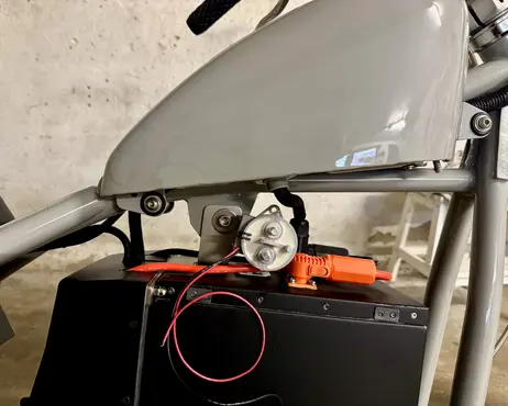 The tank fitted above the battery box, charge lead running up into it